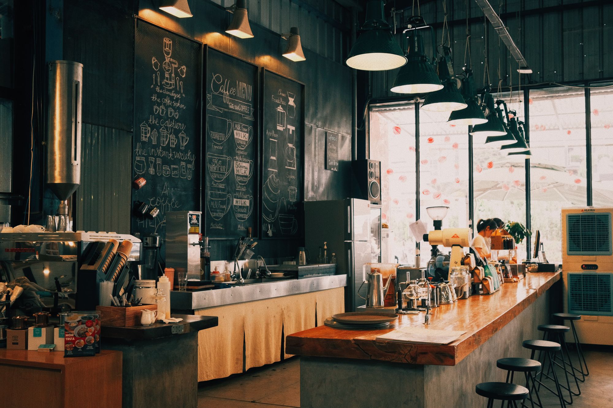 Spacious coffee shop interior with staff working behind the counter