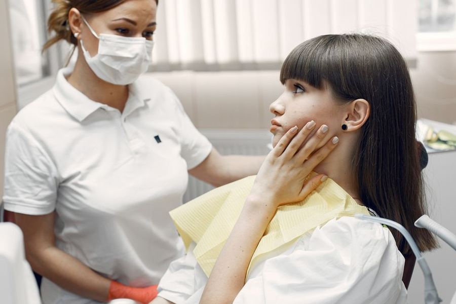 Dental professional attending a patient