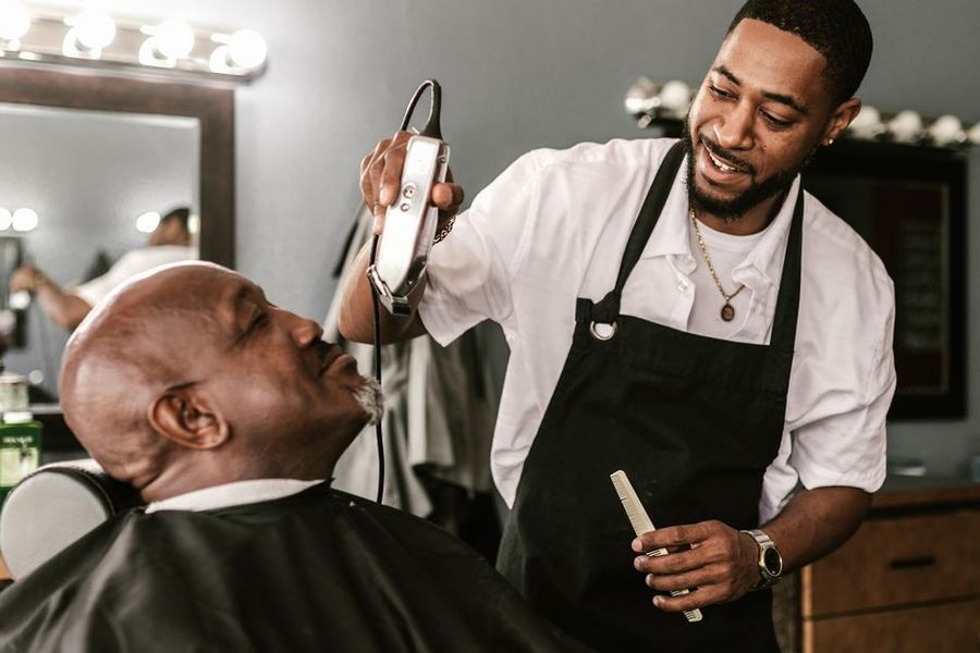 Barber cutting a client's hair in a barbershop