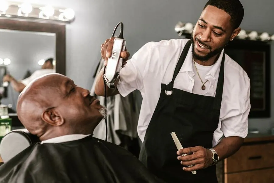 Barber cutting a client's hair in a barbershop